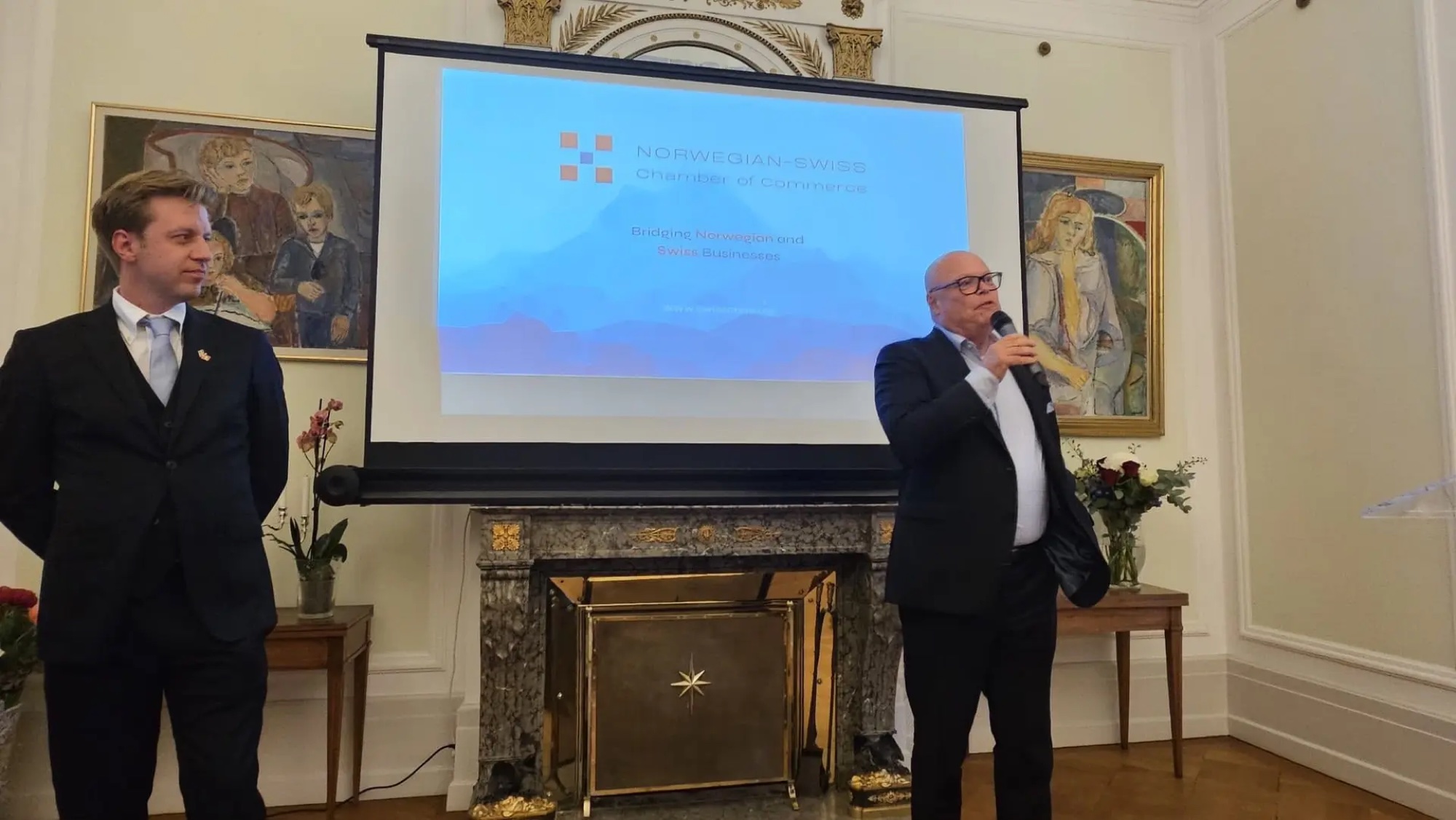 Vice-President Jan-Egil Ragnhildstveit holding the microphone, with President Odd Martin Guttulsrud next to him
